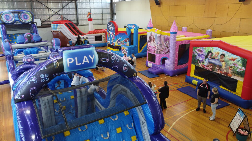 Large indoor event with multiple jumping castles and obstacle courses Narre Warren
