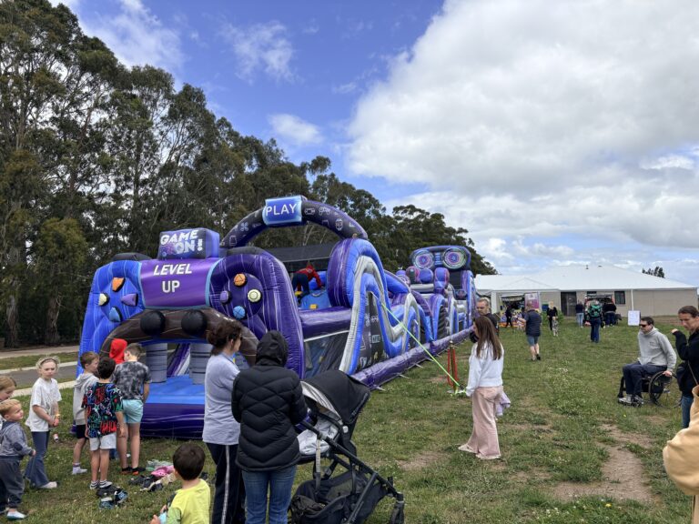 Inflatable obstacle course hire at outdoor event in Koo Wee Rup with kids and families enjoying the activity